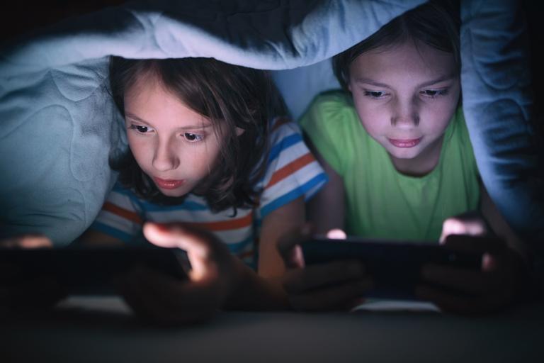 Kinderen in bed met tablet